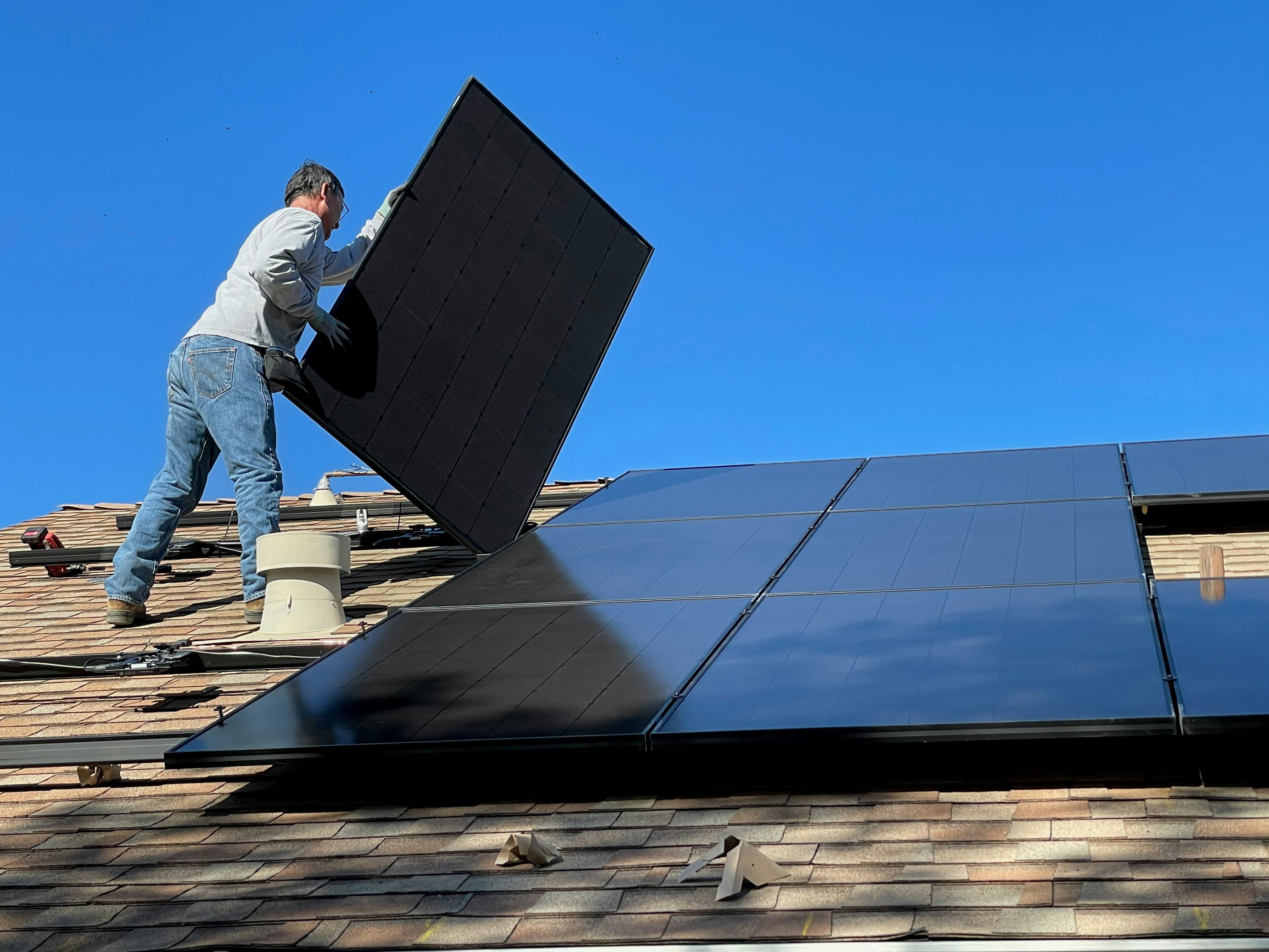 Solar panels on a rooftop against blue sky