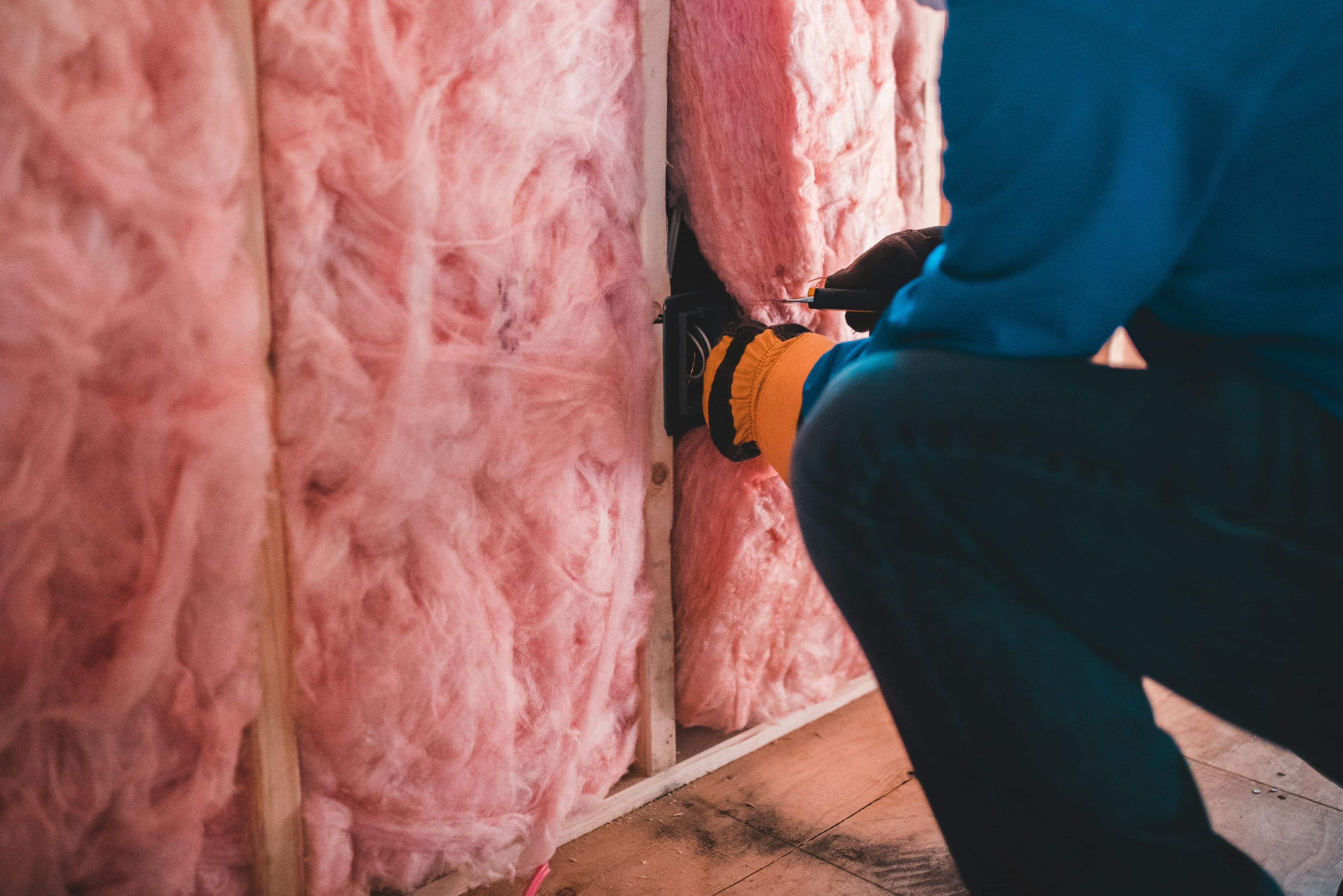 Attic insulation with foam spray coating